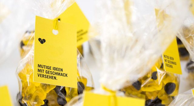 Gummibärchen-Tüten mit Etiketten in den Hausfarben der Herzblut Unternehmensbeteiligung