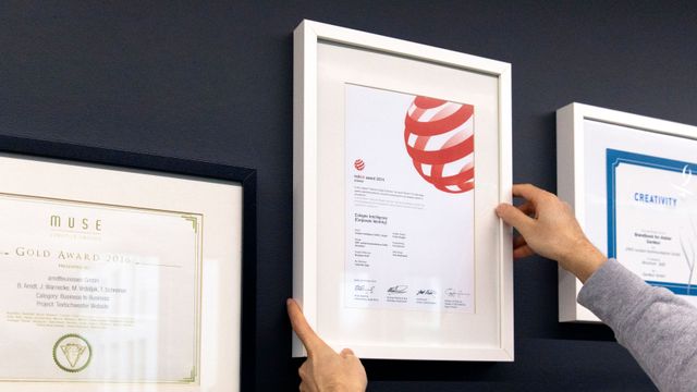 Unsere nationalen und internationalen Design-Awards im Bereich Branding. Close-up Aufnahme einer Wand mit gerahmten Design-Awards