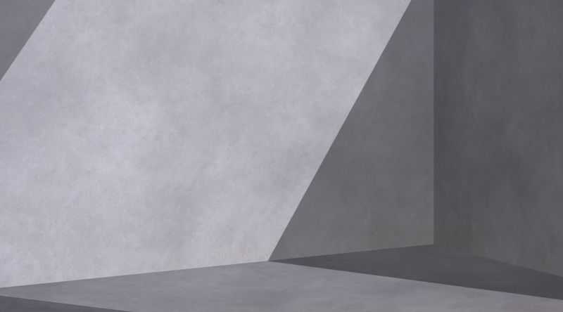 Das Zusammenspiel von Licht und Schatten auf einer Betonwand.