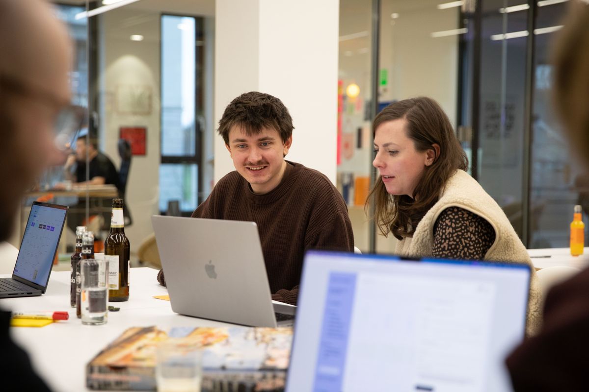 Zwei Personen sitzen gemeinsam vor einem Notebook